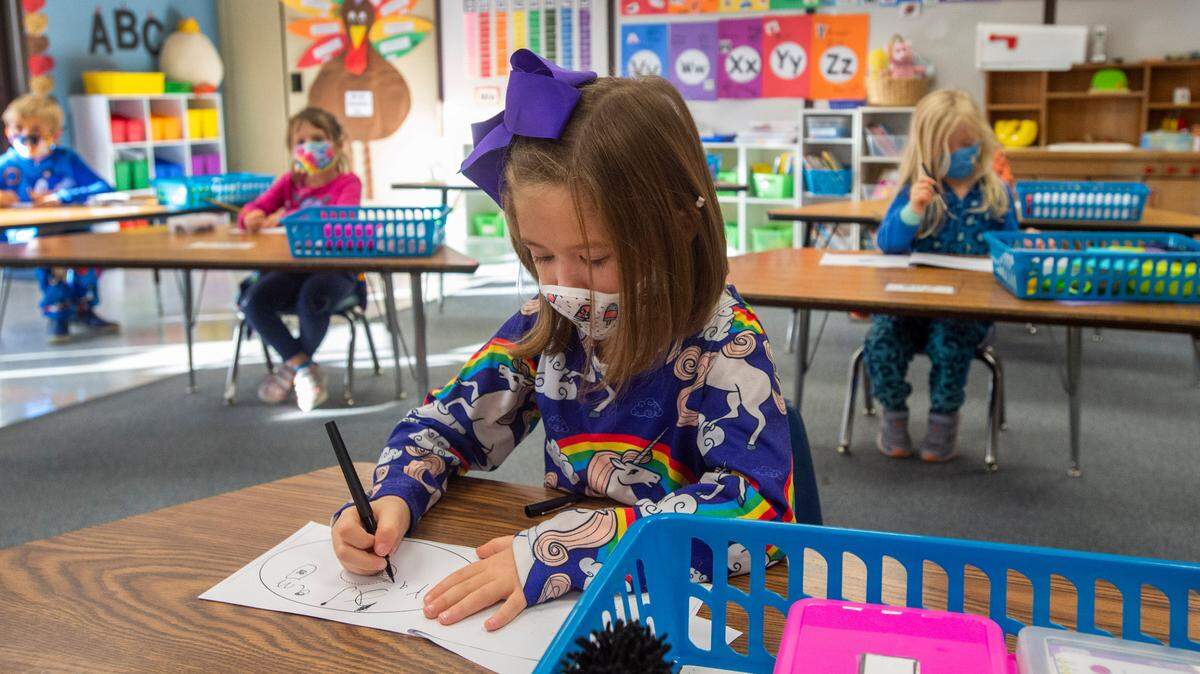 Discovery Elementary students in kindergarten teacher Kelli Willson’s class wear masks and are seated at least six feet apart Thursday, Nov. 19, 2020. The majority of kindergarten and first-grade students in the Peninsula School District are currently receiving in-person instruction, one of the few school districts in Pierce County to take that step. The addition of second-grade students has been delayed.