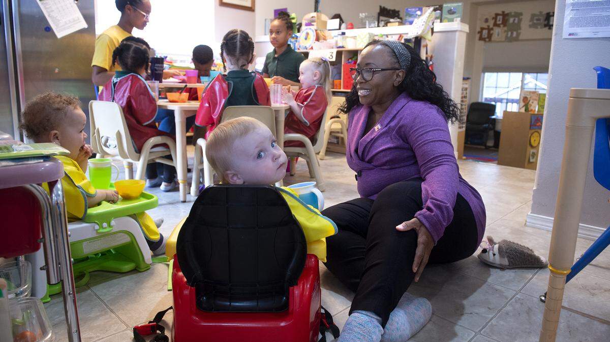 Mary Curry supervises morning snack time at her early learning/child care center at her home in Tacoma on Wednesday, May 13, 2020.