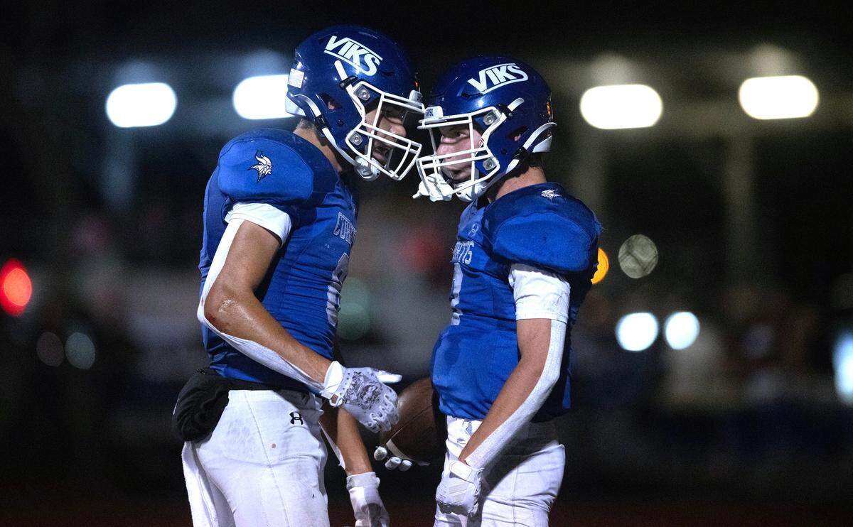 Curtis wide receiver Xavier Ahrens (left) congratulates teammate Parker Mady after his touchdown catch during Friday night’s 4A SPSL football game against the Graham Kapowsin Eagles at Viking Stadium in University Place, Washington, on Oct. 6, 2023. Graham Kapowsin won the game, 42-35.