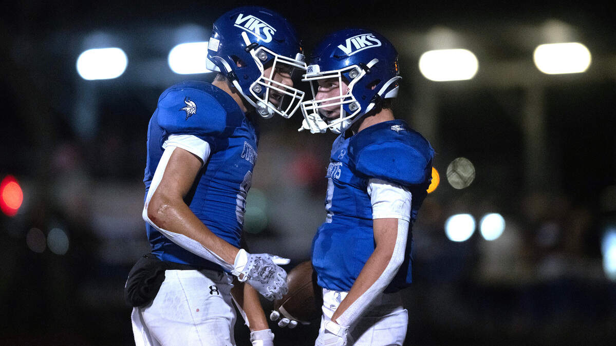Curtis wide receiver Xavier Ahrens (left) congratulates teammate Parker Mady after his touchdown catch during Friday night’s 4A SPSL football game against the Graham Kapowsin Eagles at Viking Stadium in University Place, Washington, on Oct. 6, 2023. Graham Kapowsin won the game, 42-35.