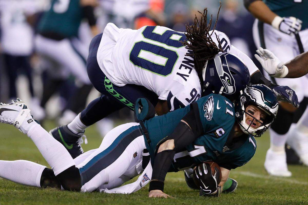 Seattle Seahawks’ Jadeveon Clowney (90) hits Philadelphia Eagles’ Carson Wentz (11) during the first half of an NFL wild-card playoff football game, Sunday, Jan. 5, 2020, in Philadelphia. (AP Photo/Julio Cortez)
