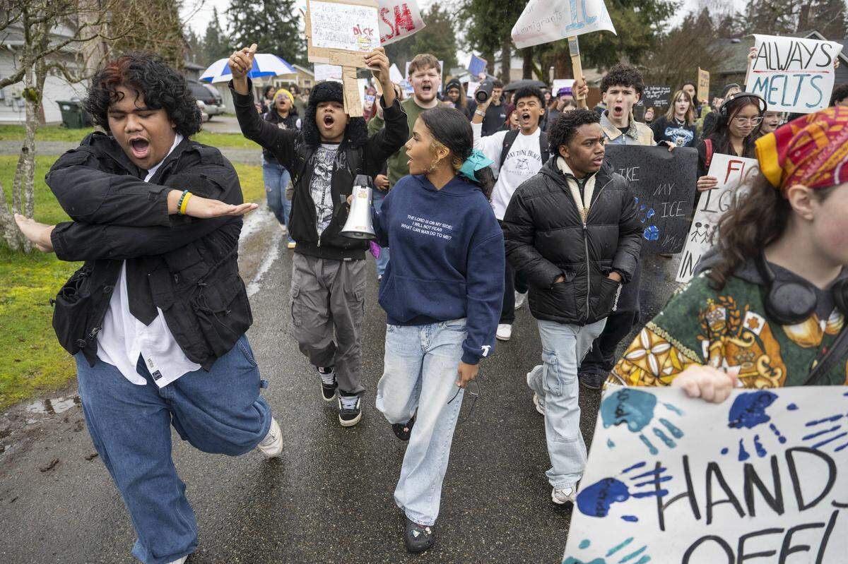 Spanaway Lake High School students, including junior Alapati Moso, left, march in protest of ICE on Thursday, Jan. 29, 2026, in Spanaway, Wash. Moso helped to organize the event.