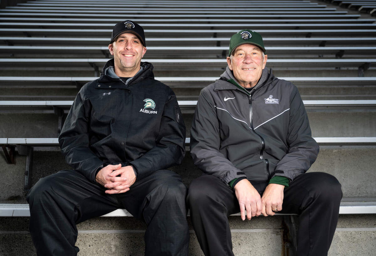 Auburn High School football coach Aaron Chantler, left, and defensive coordinator Gordon Elliott, right, pose for a portrait in the bleachers at Auburn Memorial Stadium in Auburn, Wash. on Nov. 1, 2022.