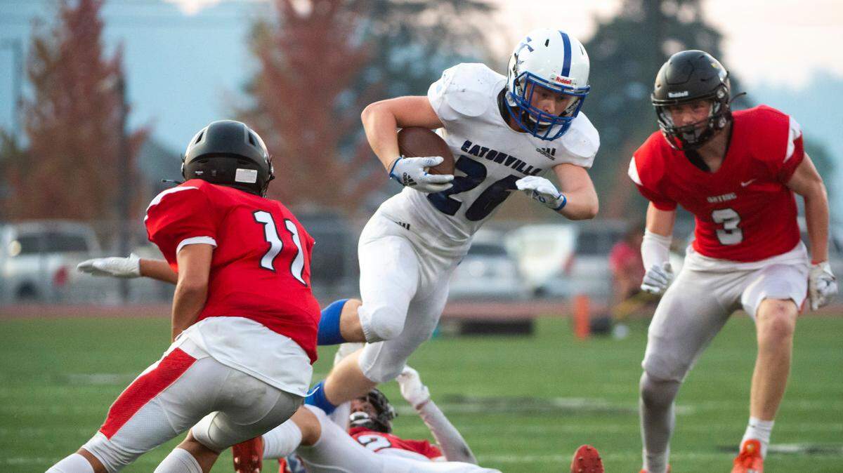 Eatonville running back Dylan Norman (26) jumps over Orting Conner Alexander (2) during the second quarter of a Friday night game at Orting Stadium in Orting Wash. on Sept. 9, 2022.