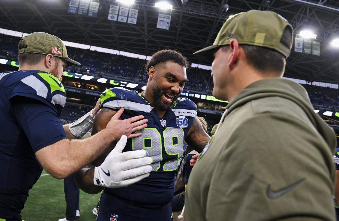 Seattle Seahawks defensive end Leonard Williams (99) and head coach Mike Macdonald embrace after the Seattle Seahawks 44-22 win against the Arizona Cardinals at Lumen Field, on Sunday, Nov. 9, 2025, in Seattle.