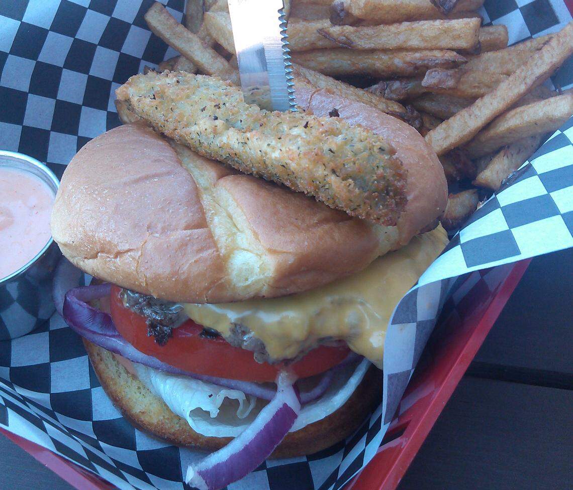 A burger with fries from Two Town Pub and Cafe after it opened in 2014. New owners will revamp the menu and reopen soon.