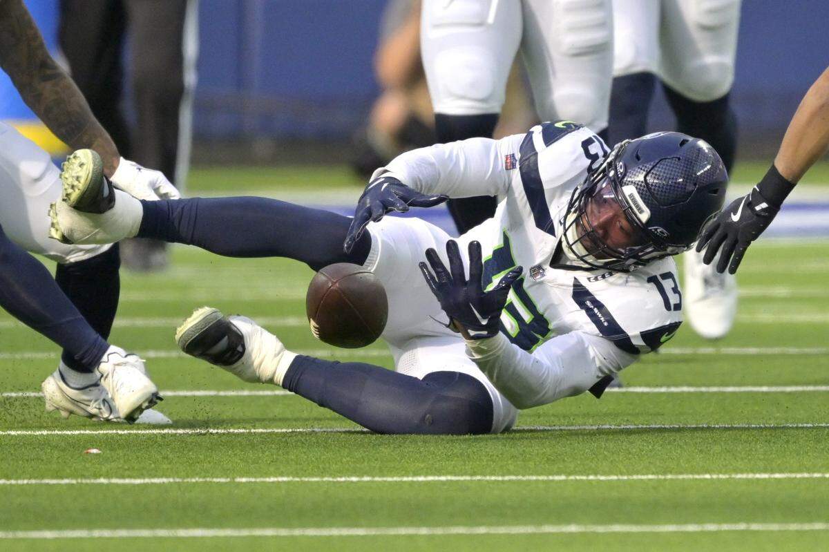 Jan 5, 2025; Inglewood, California, USA; Seattle Seahawks linebacker Ernest Jones IV (13) recovers a fumble in the first half against the Los Angeles Rams at SoFi Stadium. Mandatory Credit: Jayne Kamin-Oncea-Imagn Images