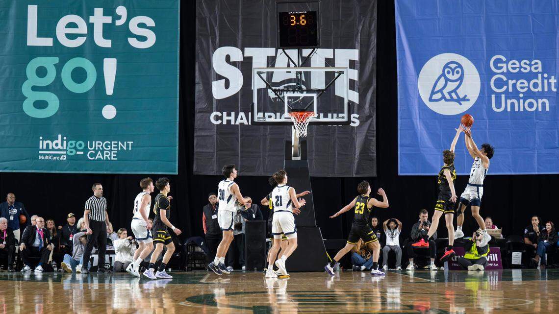 Gonzaga Prep guard Brogan Howell (5) attempts a fade-away jumper from the corner with seconds left on the clock as Puyallup forward Will Nasinec (25) defends during the fourth quarter of the Class 4A state championship game at the Tacoma Dome on Saturday, March 8, 2025, in Tacoma, Wash. Howell made the shot, giving the Bullpups a 57-55 win.