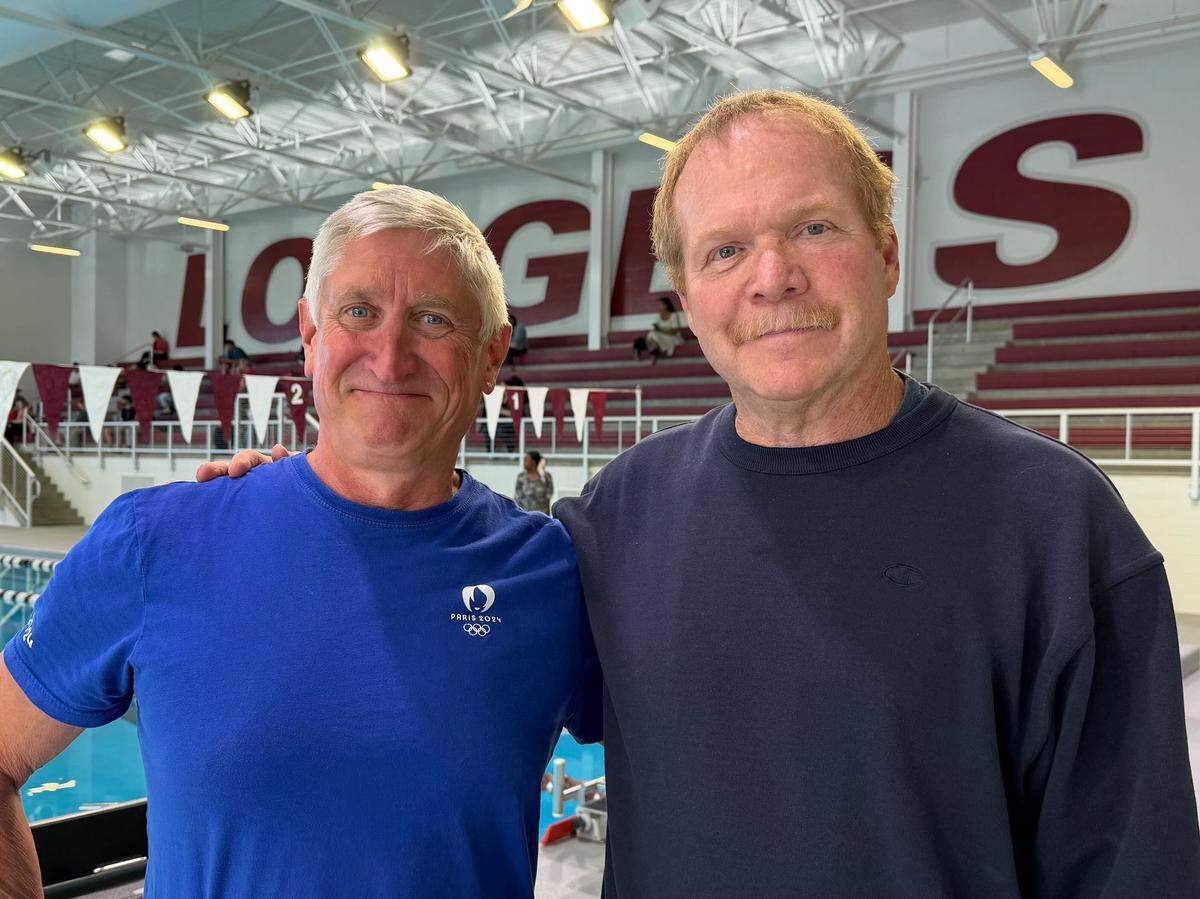 Robert Moore (left) and Robert Jackson, UPS alumni and former roommates, helped organize free swim lessons at the University of Puget Sound for 60 children this week. They stand for a poolside portrait on April 8, 2026, in Tacoma, Wash.