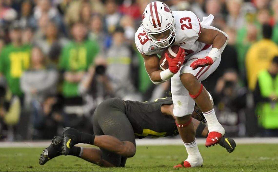 Jonathan Taylor, here running for Wisconsin against Oregon in the Rose Bowl in January, is likely to be the best running back selected in next week’s NFL draft.