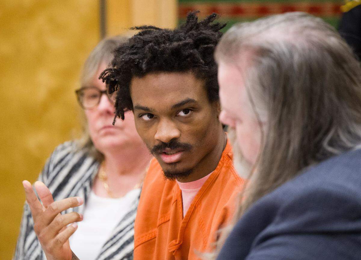 Maleke Pate (center) talks with his defense attorney during a sentencing hearing in Pierce County Superior Court on May 3, 2024, in Tacoma, Wash. In March, Pate, 24, was found guilty of fatally shooting four people in Tacoma’s Salishan neighborhood on Oct. 21, 2021.