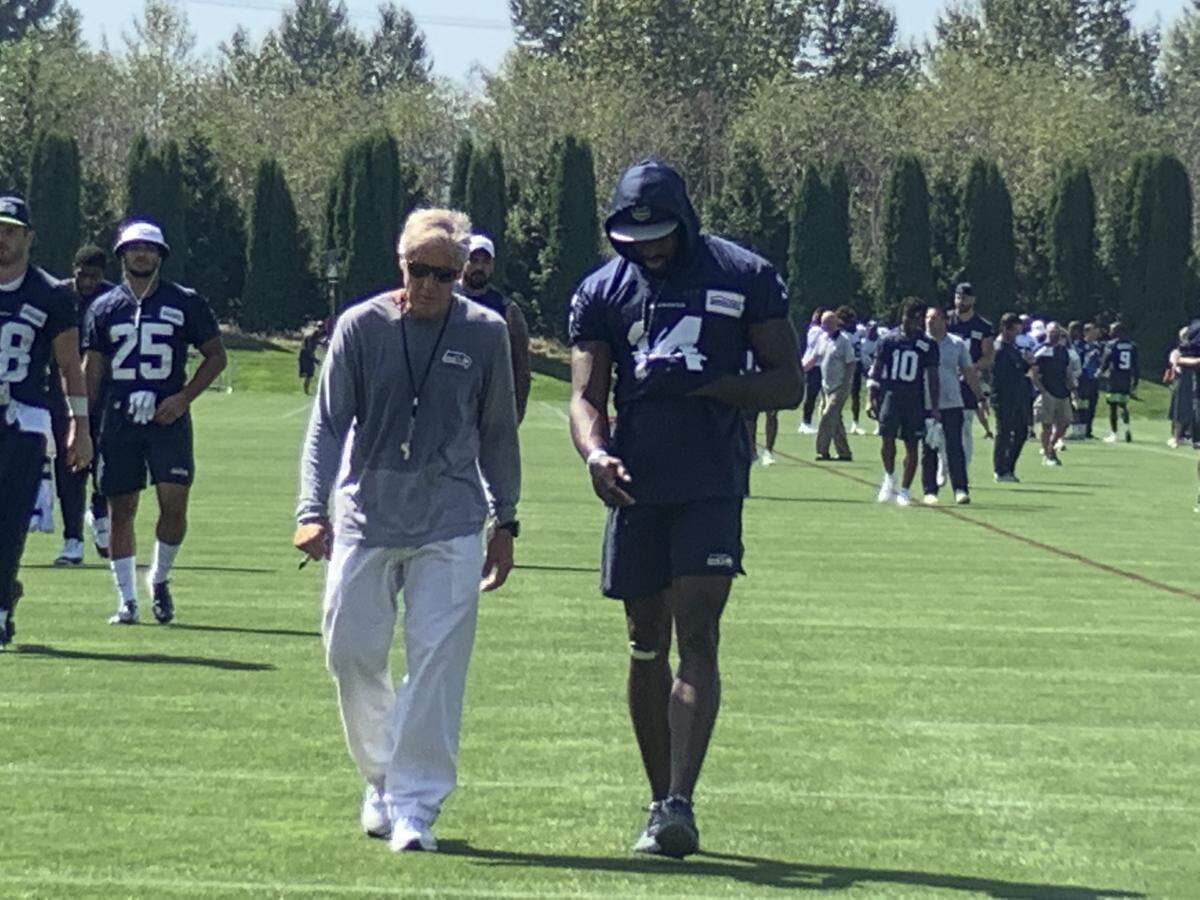 Coach Pete Carroll and rookie wide receiver DK Metcalf talk on their ways off the field following the Seahawks’ final practice of the preseason Wednesday. Metcalf then went onto the team’s indoor field to test with surgically repaired knee with sprints.