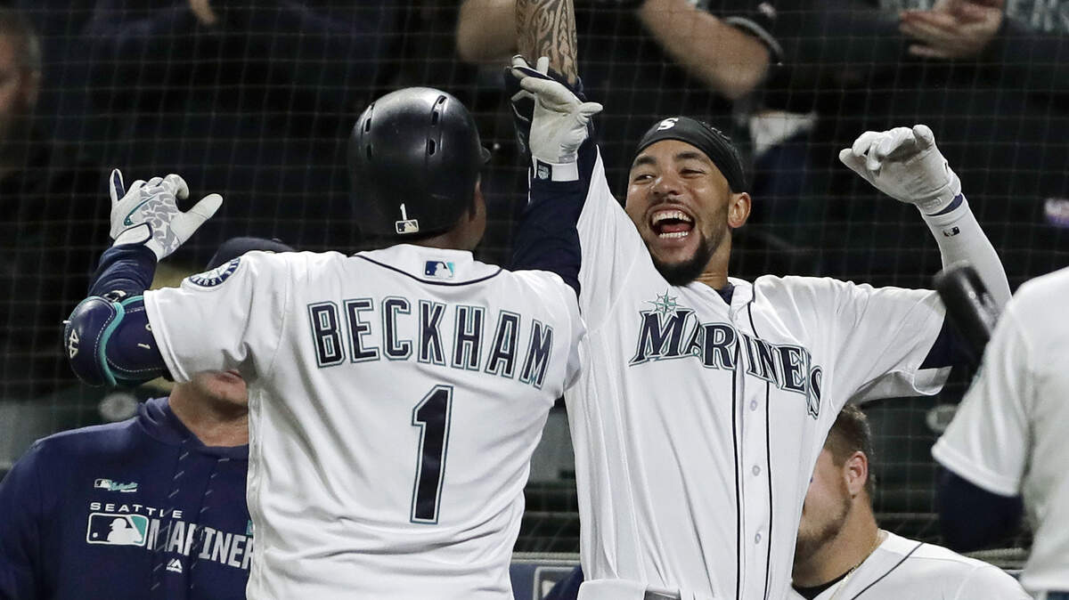Seattle Mariners’ Tim Beckham (1) celebrates with J.P. Crawford, right, after Beckham hit a go-ahead solo home run during the eighth inning of a baseball game against the St. Louis Cardinals, Tuesday, July 2, 2019, in Seattle.
