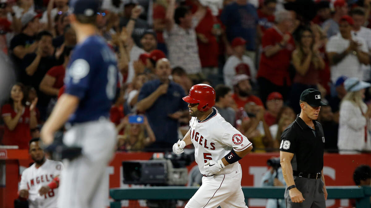 Los Angeles Angels' Albert Pujols, right, rounds third after hitting a three-run home run, as Seattle Mariners pitcher Mike Leake watches during the fourth inning of a baseball game in Anaheim, Calif., Tuesday, July 10, 2018. (AP Photo/Alex Gallardo)