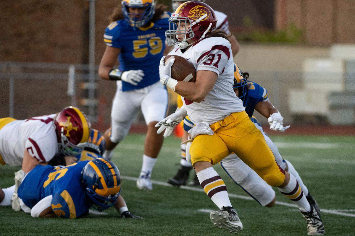 Enumclaw running back Emmit Otero looks to break through a tackle attempt by Fife’s Beau Fualaau during the first quarter of 2A SPSL game on Thursday, Sept. 22, 2022, at Fife High School in Fife, Wash.
