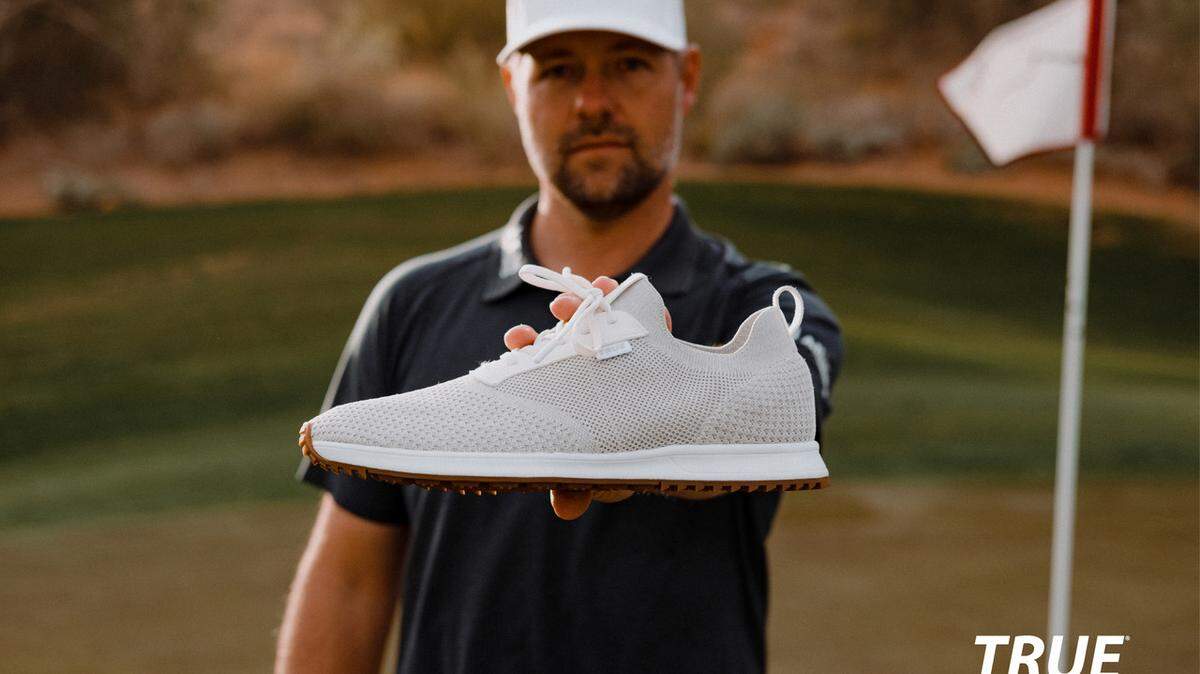 TRUE linkswear co-founder Ryan Moore poses with one of his company’s shoes. On Wednesday the company announced funding from a new investment partner.