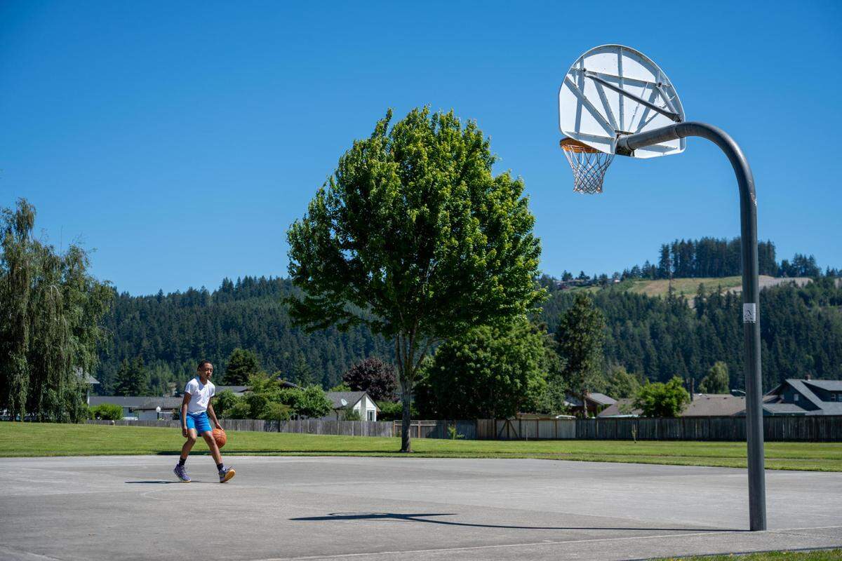 Jerius Isabell, 12, plays basketball at Rainier View Park on Friday June 24, 2022. Next year, the park will be renovating its basketball court to be covered to help extend hours as well as usage all year round.