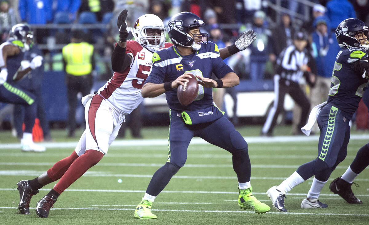 Arizona Cardinals linebacker Chandler Jones (55) sacks and strips the ball from Seattle Seahawks quarterback Russell Wilson (3) during the NFL football game at Centurylink Field on Sunday, Dec. 22, 2019.
