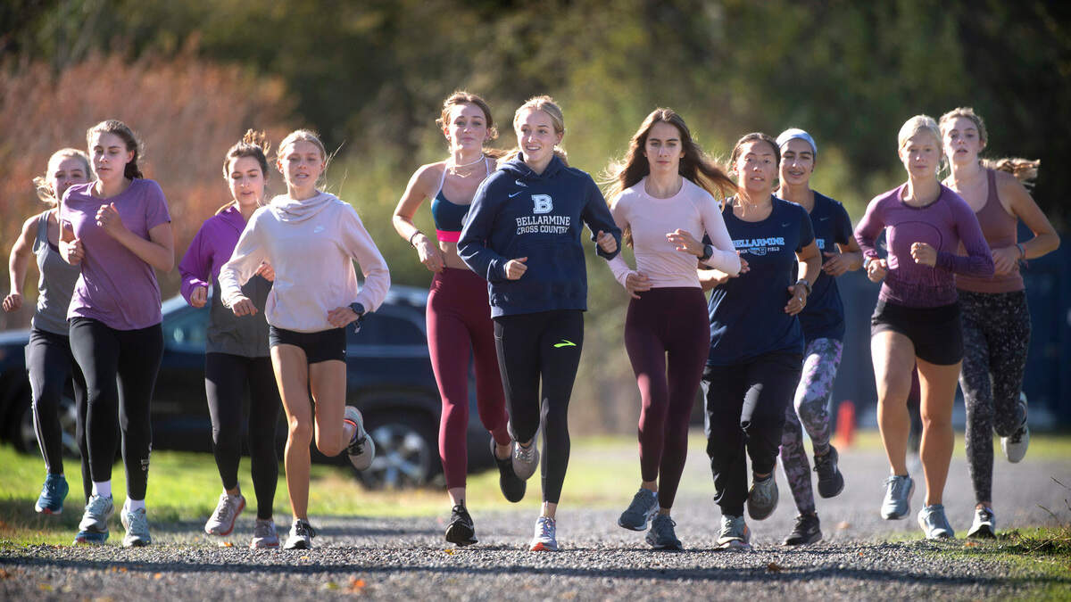 Bellarmine senior cross country state champion Ella Borsheim (center) runs with her Lion teammates during cross country practice at Bellarmine Prep High School in Tacoma, Washington, on Tuesday, Sept. 28, 2021.