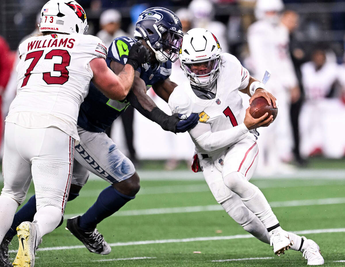 Arizona Cardinals quarterback Kyler Murray (1) scrambles under pressure from Seattle Seahawks linebacker Derick Hall (58) during the fourth quarter of the game at Lumen Field, on Sunday, Nov. 24, 2024, in Seattle, Wash.