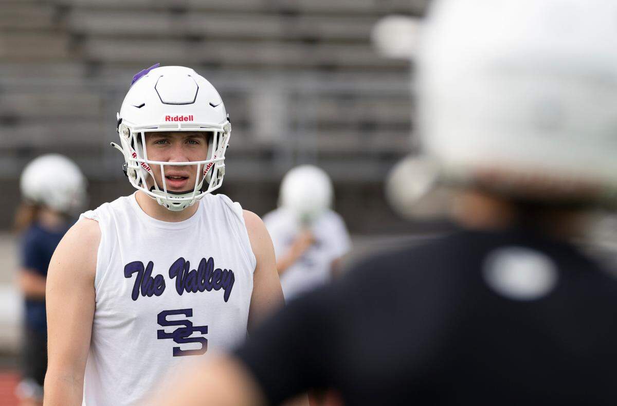 Sumner tight end Carter Cocke talks to quarterback Nate Donovan during a football practice at Sumner High School, on Thursday, Aug. 22, 2024, in Sumner, Wash.
