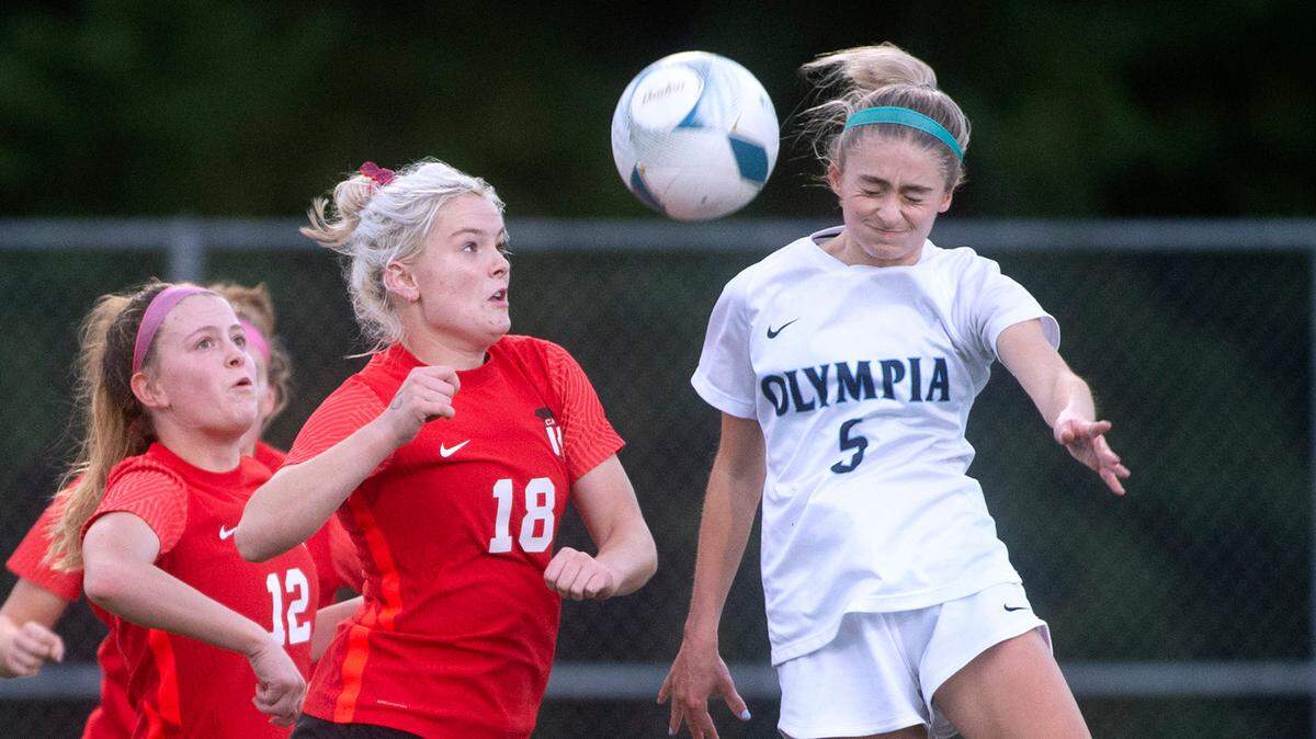 Olympia midfielder Emma Hays controls the ball over Camas forward Emerson Grafton during Thursday evening’s District 3/4 girls soccer championship game at Ingersoll Stadium in Olympia, Washington, on Nov. 4, 2021. Camas won the game, 3-1.