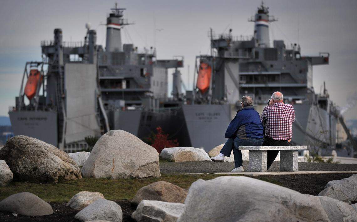 William Briody, right, with his wife Karen enjoy the break from the rain while taking photos of USS Cape Intrepid and USS Cape Island at Jack Hyde Park in Tacoma on Wednesday, October 27, 2010. Because of the break in weather, the Briody decided to come out and get some fresh air and use his Nikon D300 camera to take pictures of the ships, winter birds arriving, and the mountains. (Lui Kit Wong/Staff photographer)