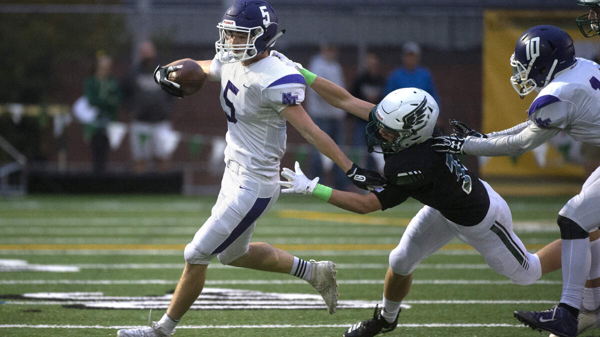 North Thurston running back Jase Marcott tries to break away from Peninsula defender Ben Goins during Thursday night’s 3A SSC league opener football game at Roy Anderson Field in Gig Harbor on Sept. 19, 2019.