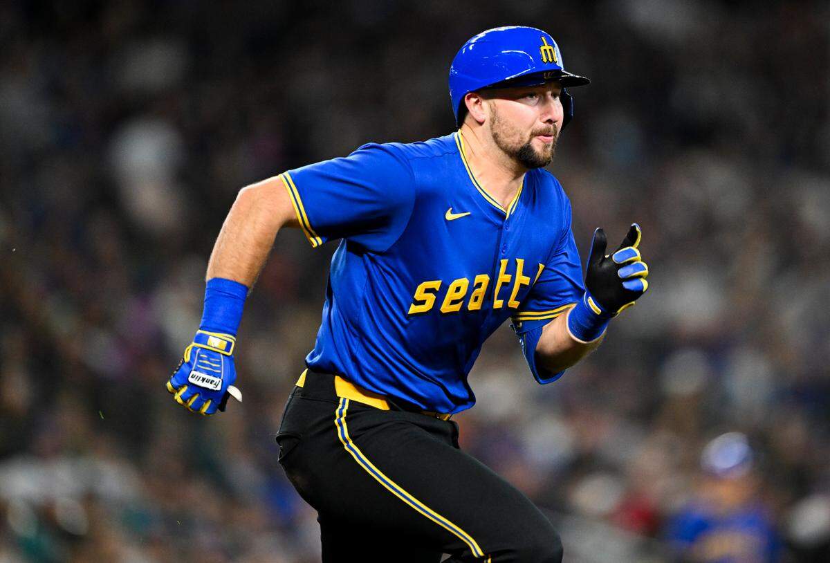 Seattle Mariners catcher Cal Raleigh (29) runs to a first base off during the third inning of the game at T-Mobile Park, on Friday, June 14, 2024, in Seattle, Wash.