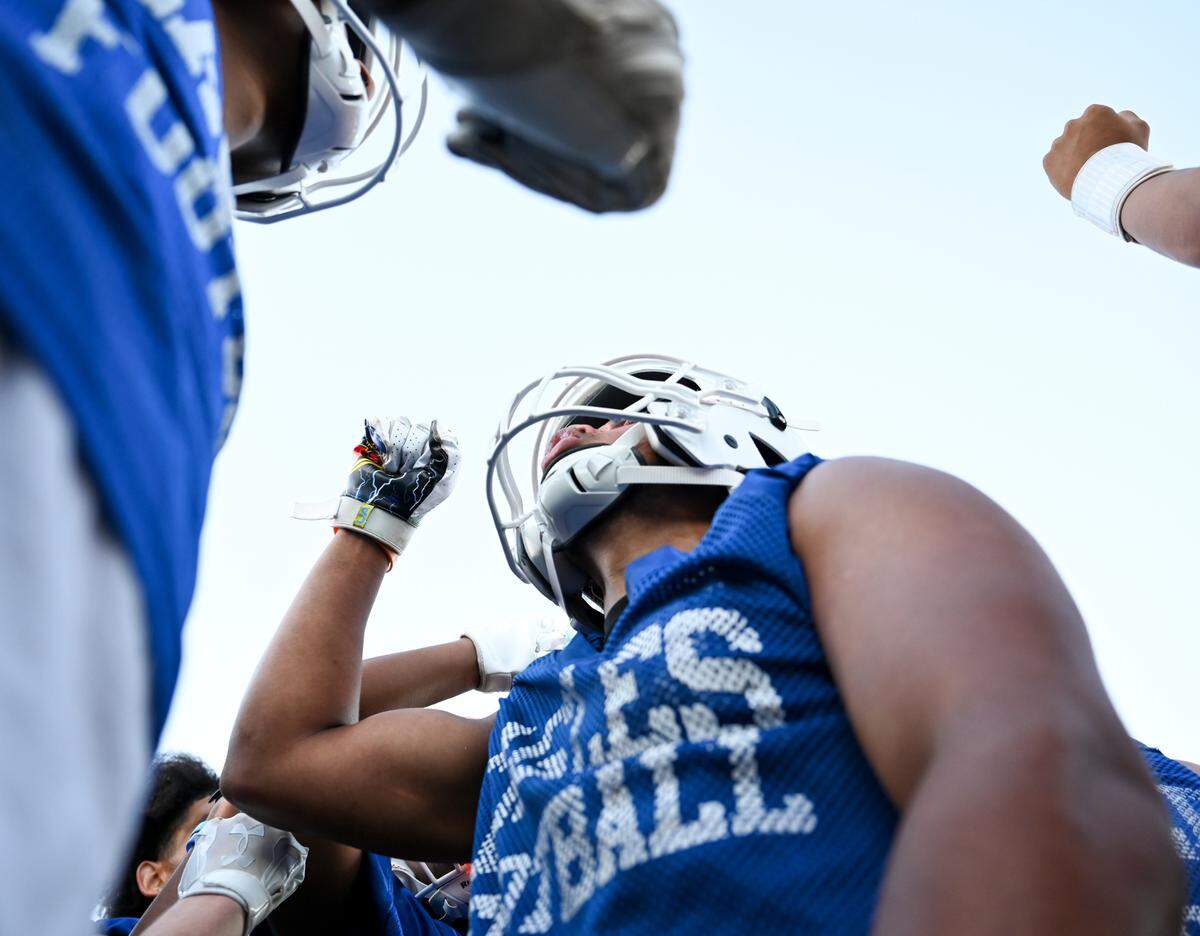 Student-athletes huddle during a football practice at Graham-Kapowsin High School, Wednesday, Aug. 16, 2023, in Graham, Wash.