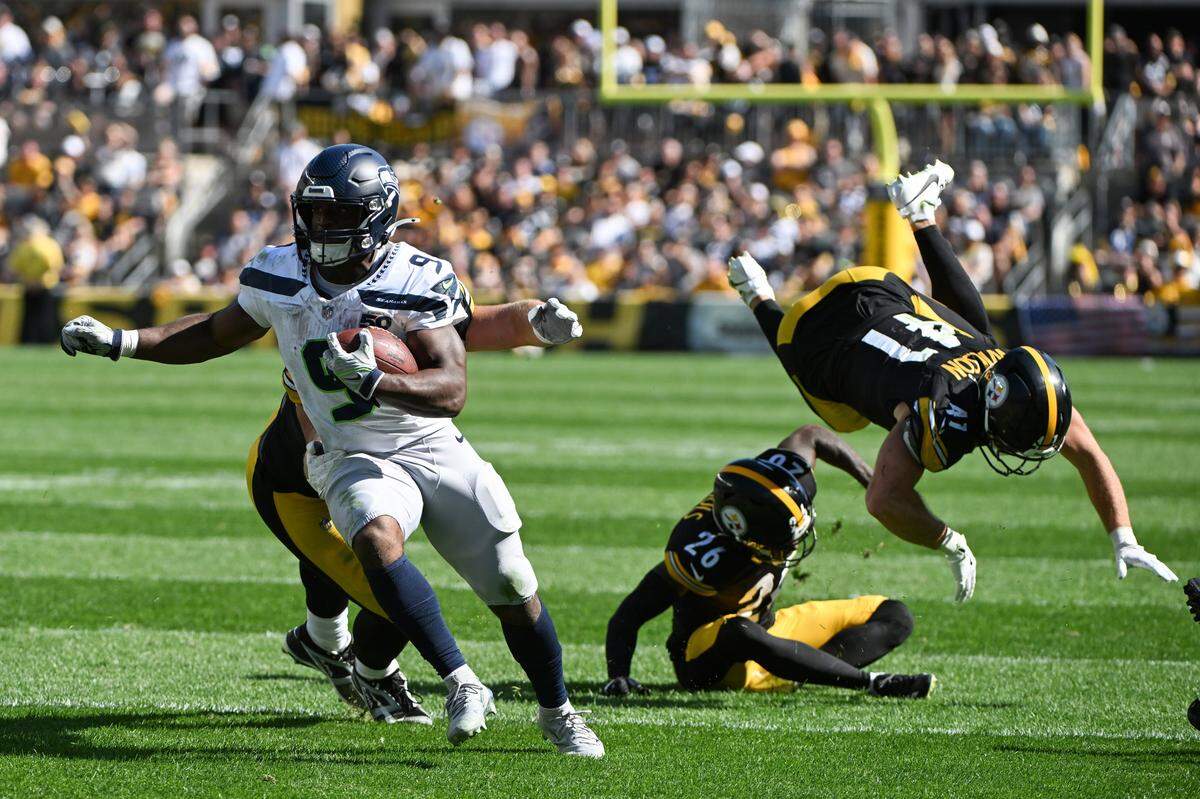 Sep 14, 2025; Pittsburgh, Pennsylvania, USA; Seattle Seahawks running back Kenneth Walker III (9) scores a touchdown in front of Pittsburgh Steelers defenders Brandin Echols (26) and Payton Wilson (41) during the second half at Acrisure Stadium. Mandatory Credit: Barry Reeger-Imagn Images