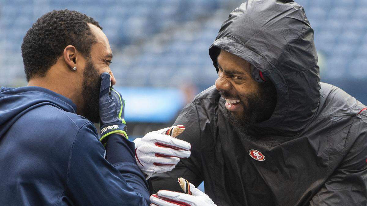 Pro Bowl wide receiver Doug Baldwin (left) and former Seattle three-time All-Pro cornerback Richard Sherman share a laugh during pregame warmups at CenturyLink Field Dec. 2, before the former Seahawks and Stanford teammates played against each other for the first time. They will do it again Sunday when Baldwin’s Seahawks play at Sherman’s 49ers in Santa Clara, Calif.