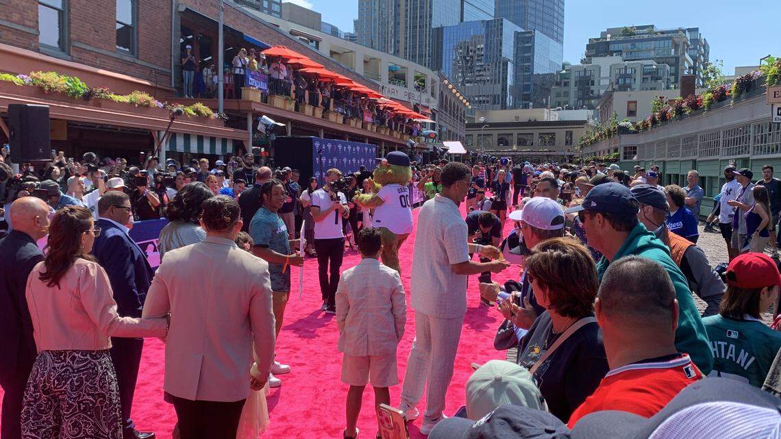 Mariners slugger Julio Rodriguez stops to sign autographs for cheering home fans as he walks down a uniquely Seattle red carpet at Pike Place Market July 11, 2023, hours before he played in the 93rd MLB All-Star Game at nearby T-Mobile Park.