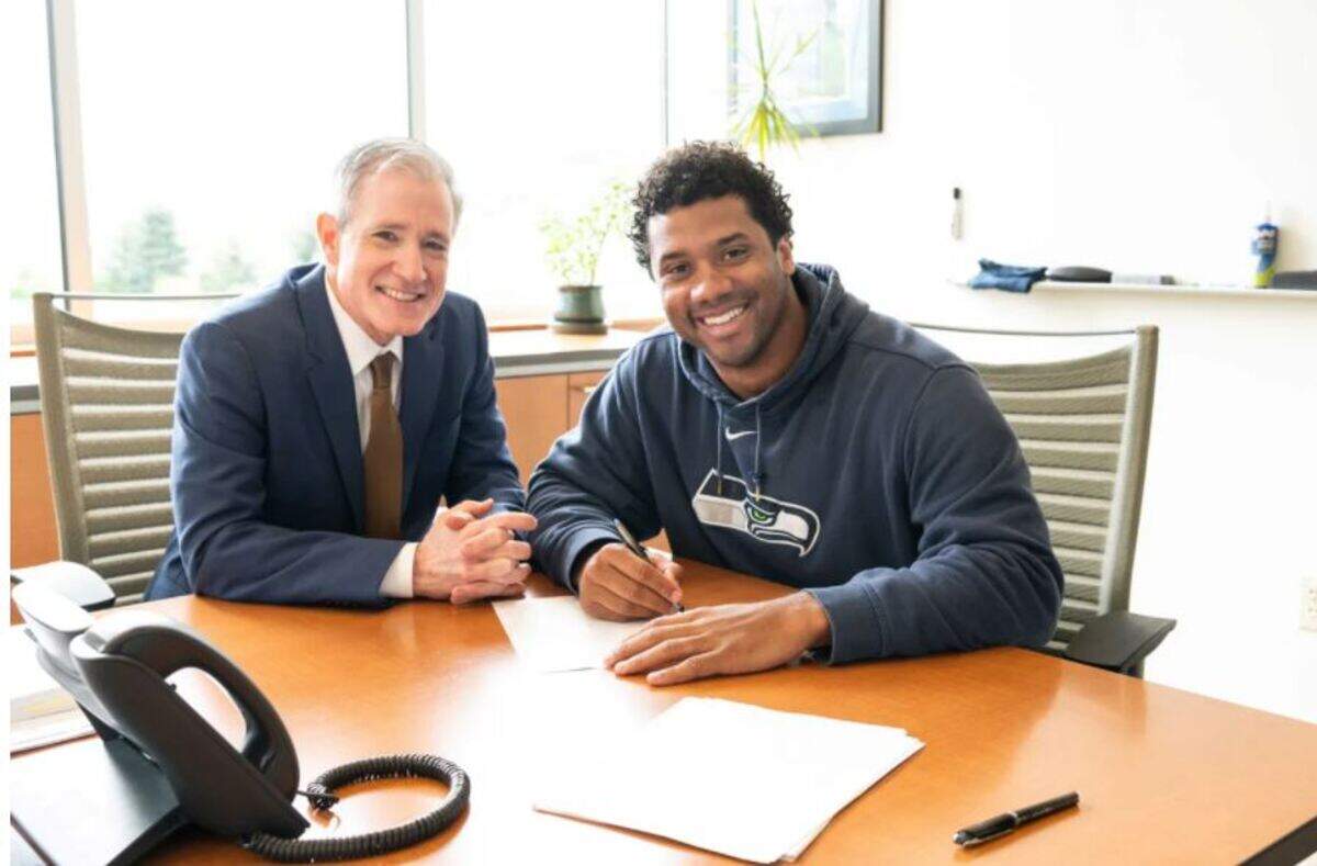 Agent Mark Rodgers with Russell Wilson in April 2019 when the quarterback signed an NFL-record, $140-million contract extension with the Seahawks.