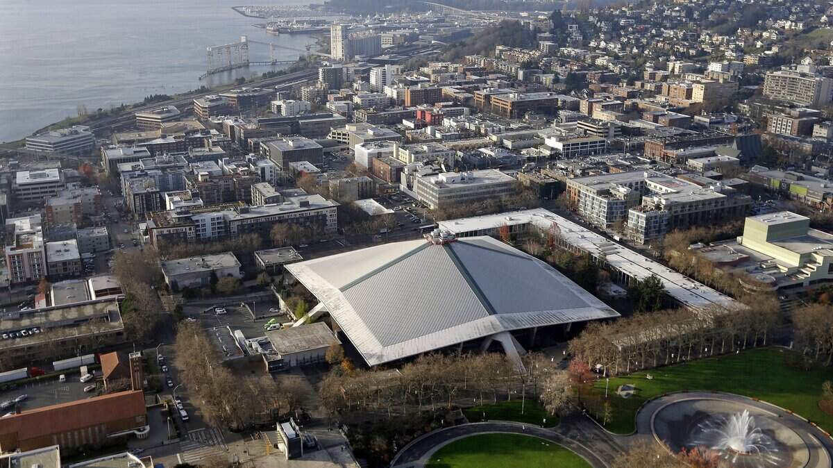 The iconic sloped roof of KeyArena, center, a sports and entertainment venue at the Seattle Center, is seen from above Dec. 4, 2017. An NHL team is scheduled to begin playing there in a few years.