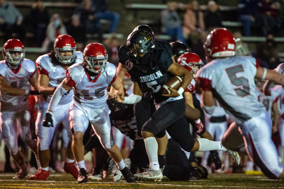 Lincoln quarterback Gabarri Johnson splits through the Stanwood defense for a on his way to the endzone for a touchdown during the second quarter of a 3A winner-to-state playoff game at the Lincoln Bowl in Tacoma on Friday night.