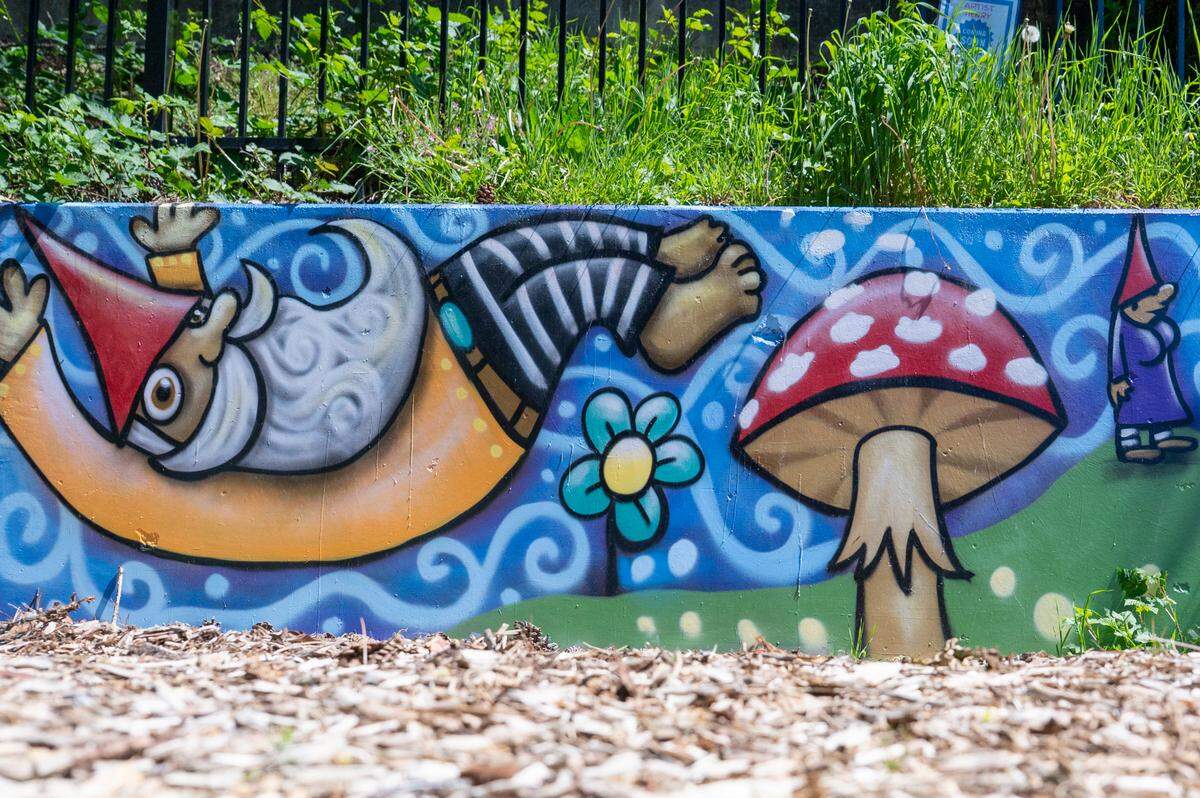 Painted murals add color to the beautified alleyway along South D Street, an effort of the South End Neighborhood Council and volunteers. Photographed on Monday, May 5, 2025, in the South End of Tacoma.