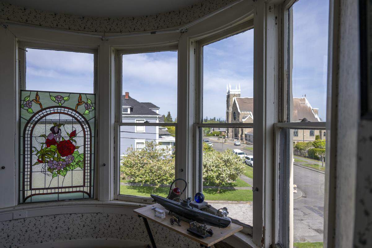 Original bay windows look out over North J Street from the second level of a house featured in Tacoma's historic homes tour on Thursday, April 30, 2026, in the North End of Tacoma, Wash.