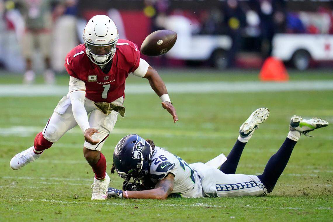 Arizona Cardinals quarterback Kyler Murray (1) fumbles the ball after being hit by Seattle Seahawks safety Ryan Neal (26) during the first half of an NFL football game in Glendale, Ariz., Sunday, Nov. 6, 2022. The Seahawks recovered the ball. (AP Photo/Ross D. Franklin)