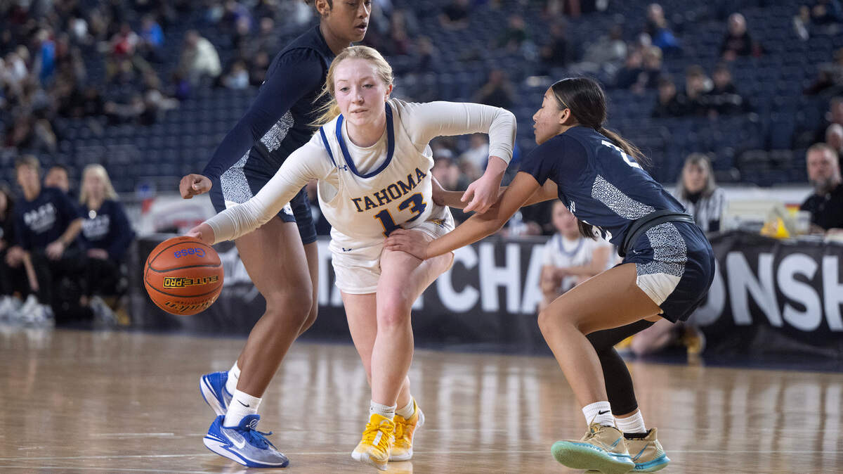Tahoma’s Lily Cavanaugh pushes the ball past Bellarmine defenders Kyla Frazier (left) and Jaylee Laxamana during Wednesday morning’s opening-round game of the 4A girls state basketball tournament in the TacomaDome in Tacoma, Washington, on Wednesday, Feb. 28, 2024. Tahoma won the game, 53-38.