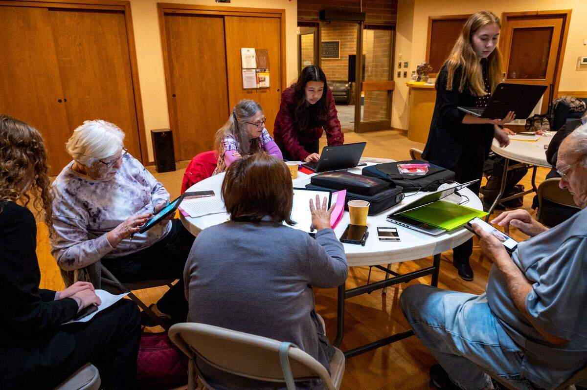 Fife High School students in the Future Business Leaders of America help seniors during a free monthly workshop on how to navigate technology on Friday, Oct. 21, 2022, at the Milton Activity Center in Milton, Wash.
