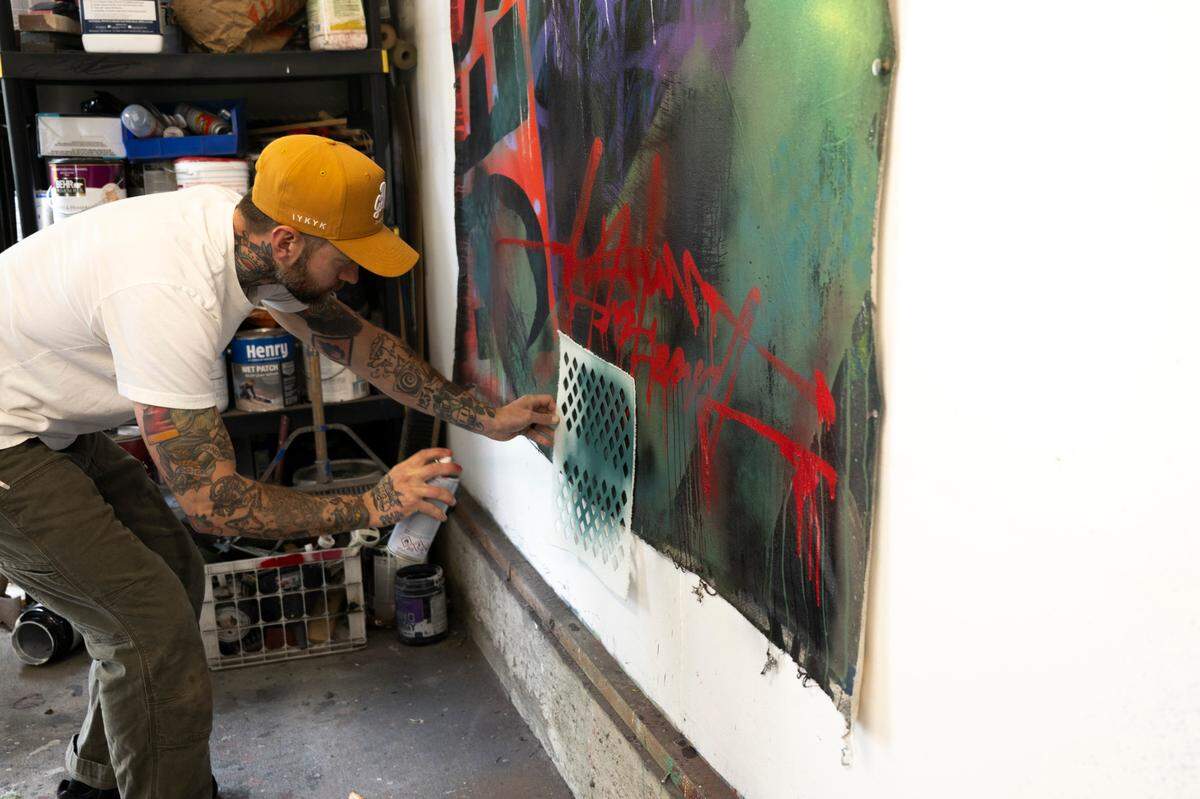 Typograffic abstraction artist Jared Michael Haviland works on a piece of his artwork in his home studio, on Monday, May 6, 2024, in Tacoma.