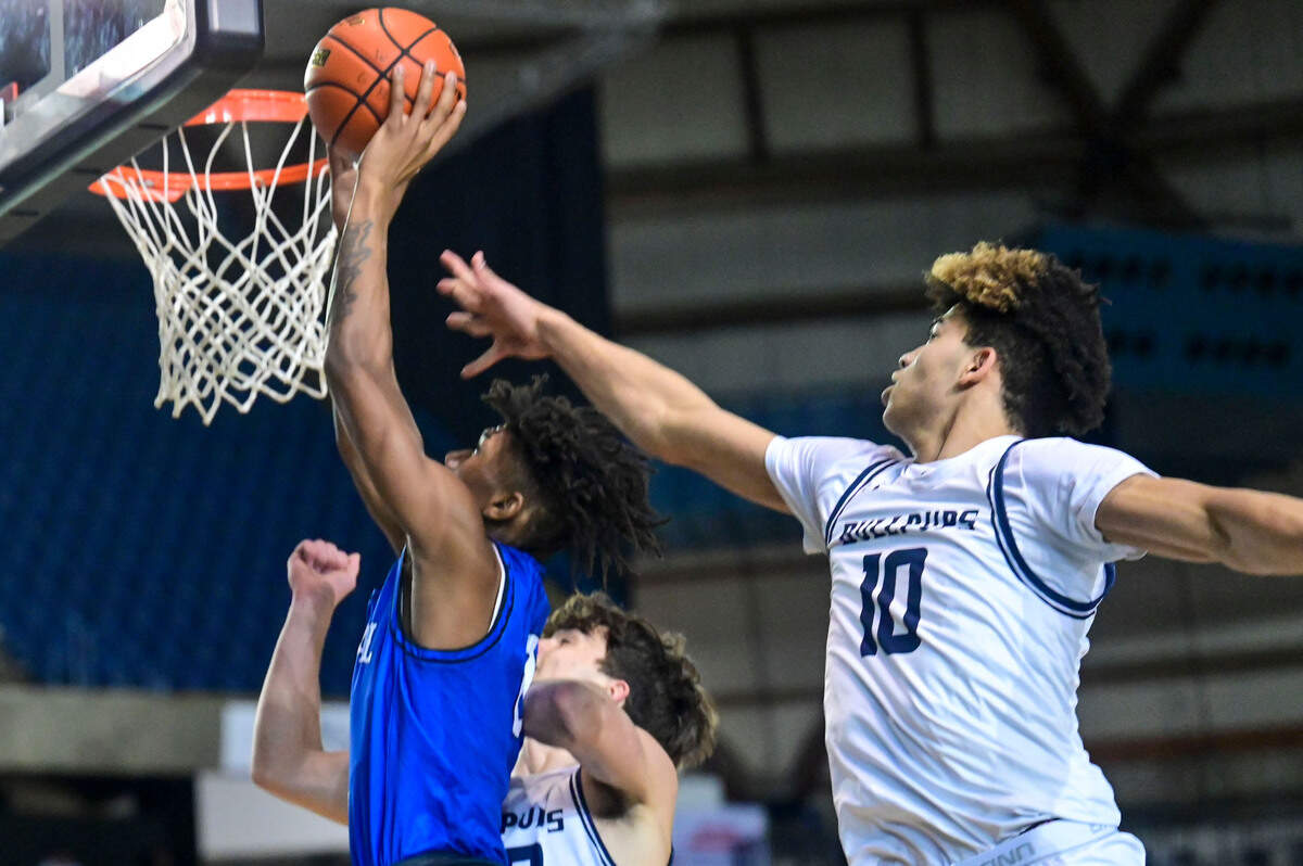 Federal Way wing Vaughn Weems (0) puts in a layup as Gonzaga Prep forward Jamil Miller (10) defends during the first quarter of a Class 4A state tournament game on Wednesday, March 2, 2022, at the Tacoma Dome, in Tacoma, Wash.