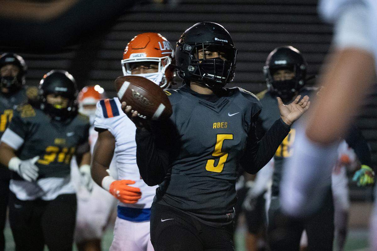 Lincoln’s Gabarri Johnson runs for a two-point conversion during the third quarter. Lincoln played Lakes in a football game at the Lincoln Bowl in Tacoma, Wash., on Friday, March 19, 2021.
