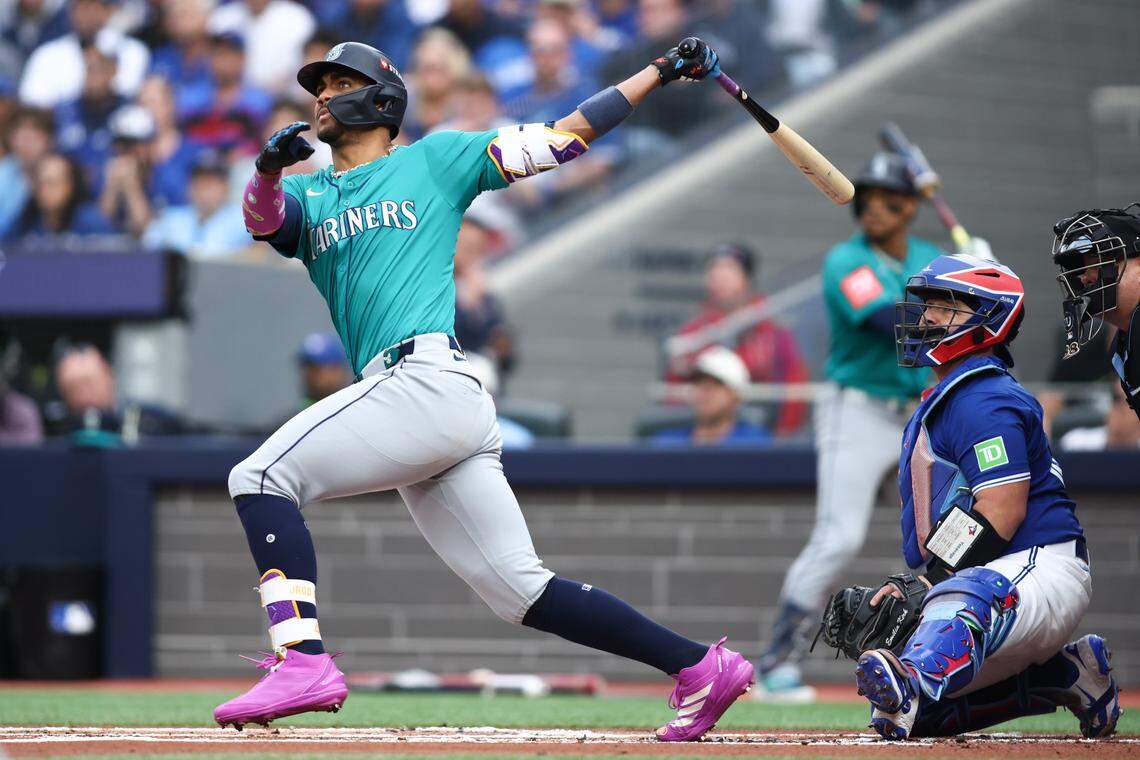 TORONTO, ONTARIO - OCTOBER 13: Julio RodrÃguez #44 of the Seattle Mariners hits a three run home run against the Toronto Blue Jays during the first inning in game two of the American League Championship Series at Rogers Centre on October 13, 2025 in Toronto, Ontario. (Photo by Cole Burston/Getty Images)