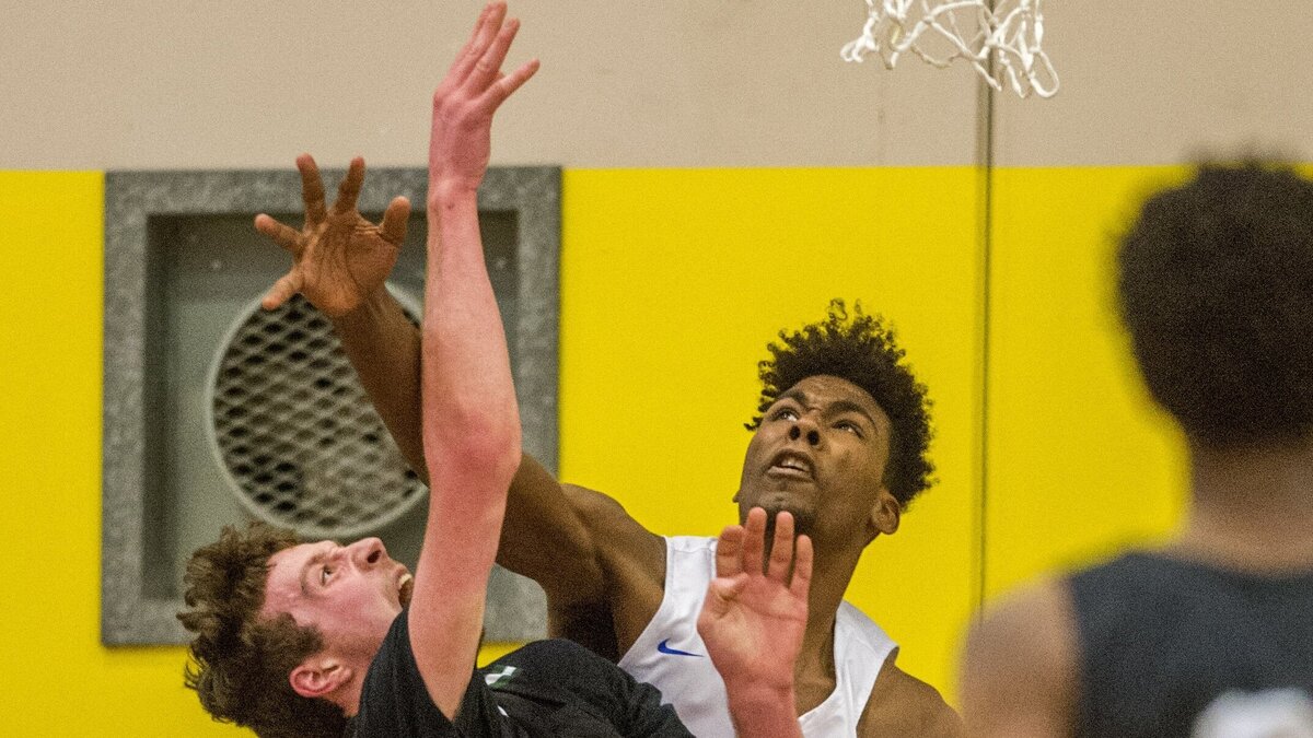 Tari Eason of Federal Way High School blocks the shot of Kyle Bigovich of Jackson in a boys AAAA basketball playoff game at Puyallup High School, February 23, 2019. Federal Way beat Jackson to advance to the next round, which is in the Tacoma Dome.