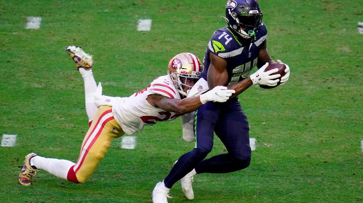 Seattle Seahawks wide receiver DK Metcalf (14) makes a catch as San Francisco 49ers cornerback Jason Verrett (22) defends during the first half of an NFL football game, Sunday, Jan. 3, 2021, in Glendale, Ariz. With the catch, Metcalf passed former Seahawk Steve Largent﻿’s single-season franchise record of 1,287 receiving yards set in 1985. (AP Photo/Ross D. Franklin)