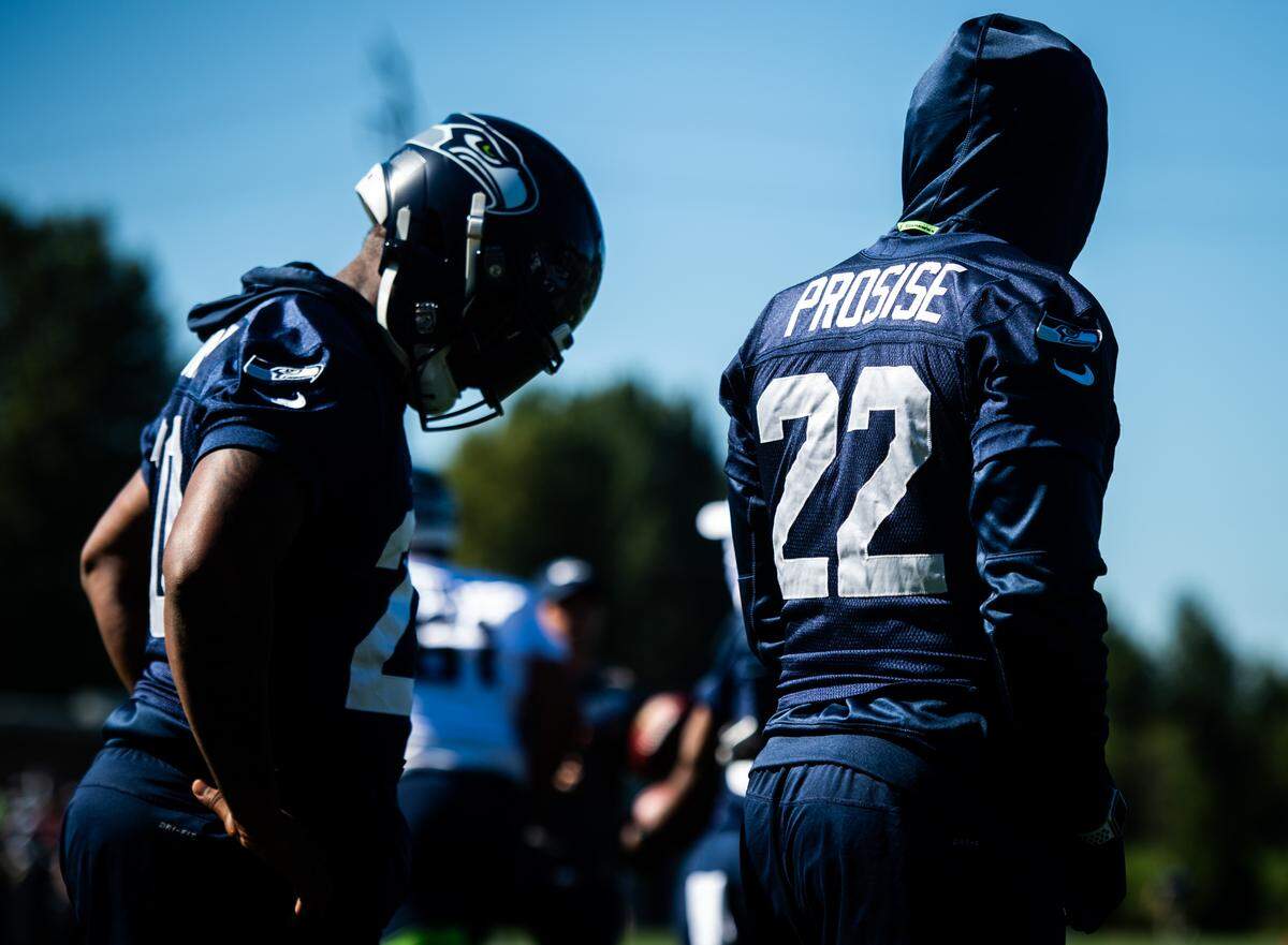 C.J. Prosise (22) and Rashaad Penny walk the field during the Seattle Seahawks training camp at the Virginia Mason Athletic Center in Renton, Wash., on Thursday, July 25, 2019.