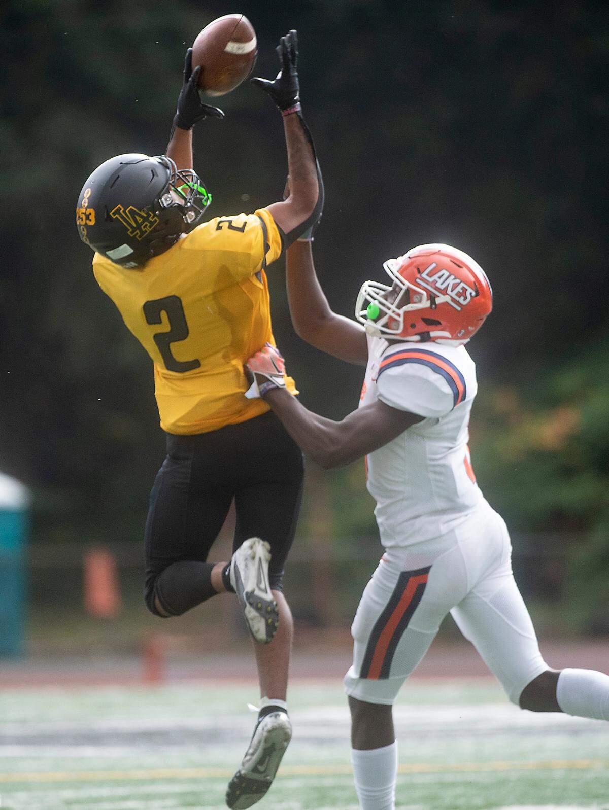 Lincoln wide receiver Drake Granberry pulls in a reception over Lakes defensive back Oakland Cotton during Saturday afternoon’s football game at Lincoln Bowl in Tacoma, Washington, on Oct. 22, 2022.