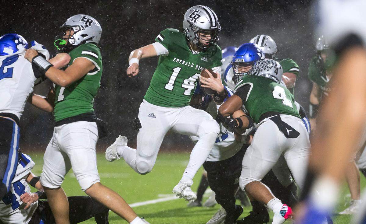 Emerald Ridge quarterback Jake Schakel leaps into the end zone for a two-point conversion during Friday night’s 4A district football game against the Bothell Cougars at Sparks Stadium in Puyallup, Washington, on Nov. 3, 2023. Emerald Ridge won the game, 50-36.